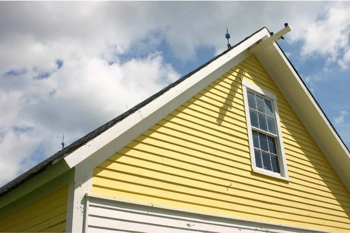 A yellow painted house exterior showing sun fading